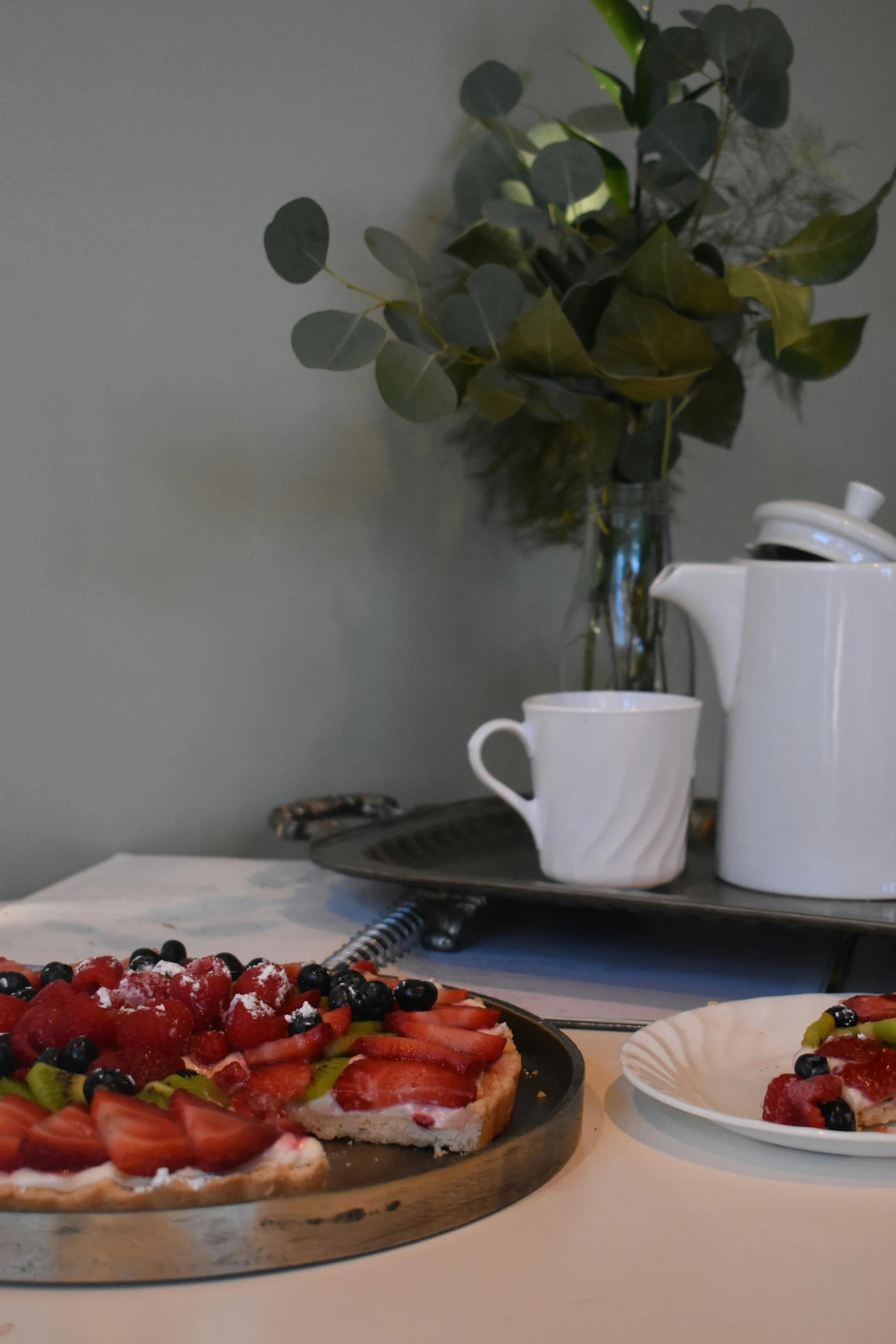 a plate and bowl of fruit sitting on top of a counter