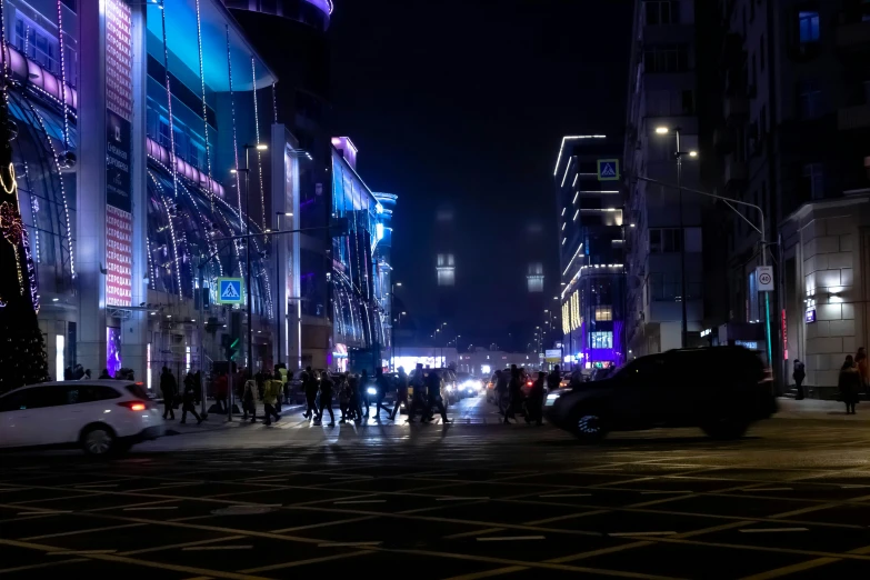 night time cityscape showing many buildings and cars