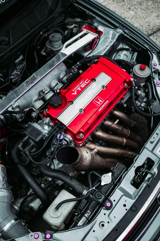 the engine compartment of an automobile with red boxes on its hood