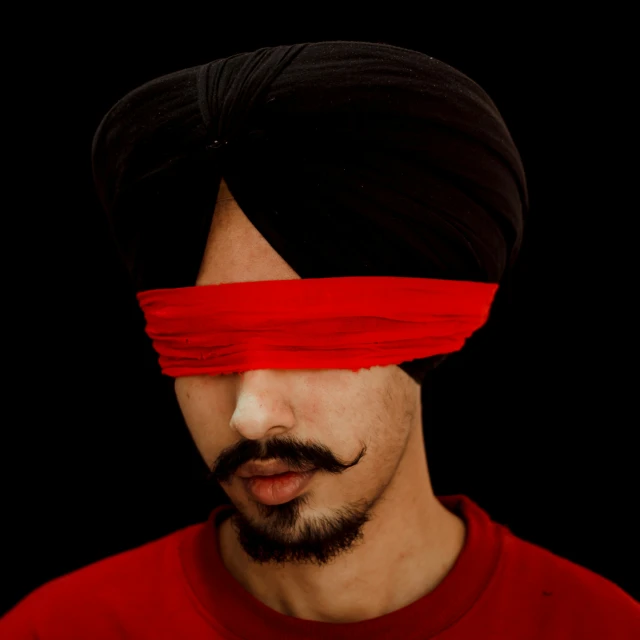 a man with a red blind on his face