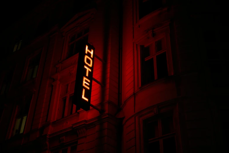 a close up of a neon sign on the side of a building