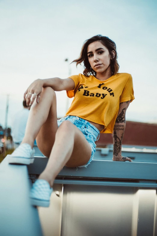 a woman sitting on top of a metal pole