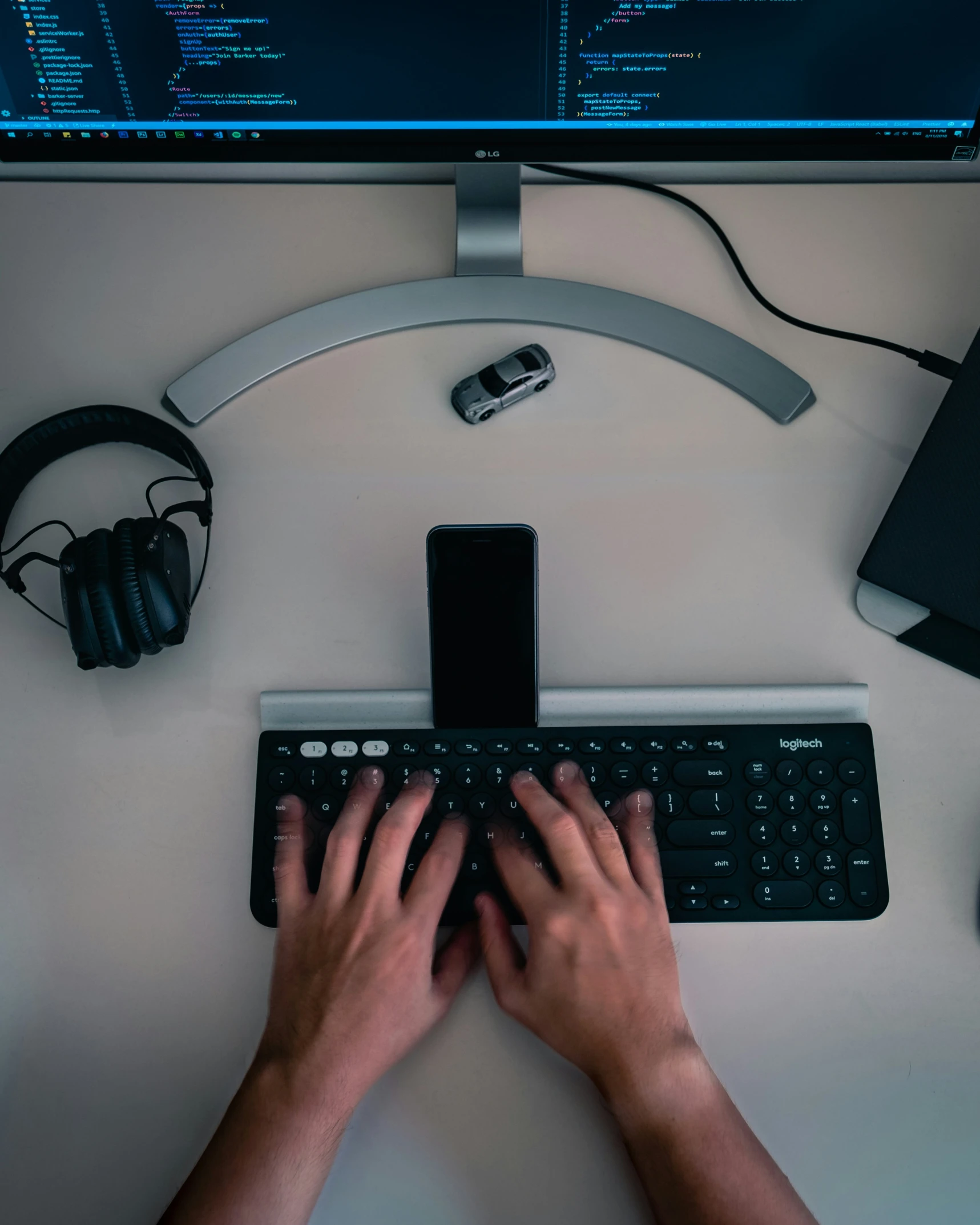 a person typing on a computer keyboard on a desk