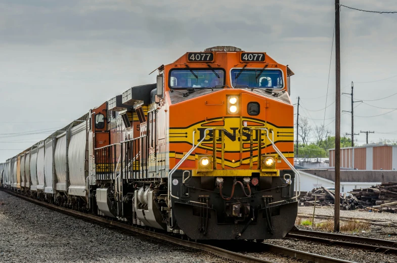 a train going down the tracks with its lights on