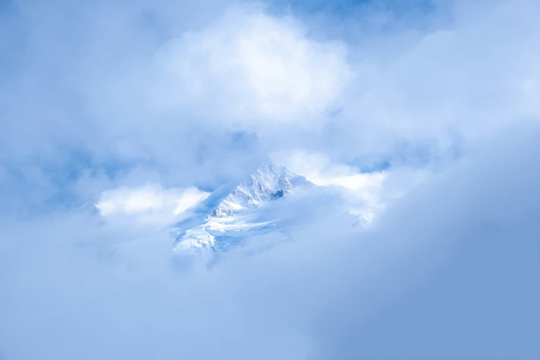 the ski lift is moving in front of the mountain top