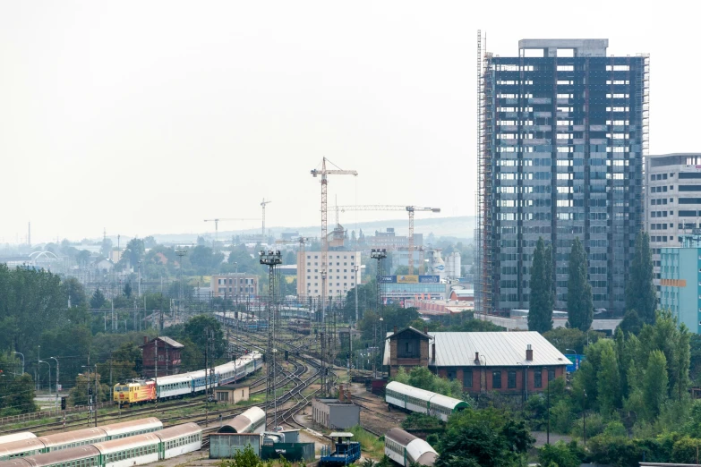 city scene with tracks running alongside buildings