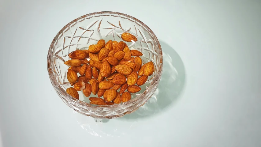 a glass bowl with a pile of nuts