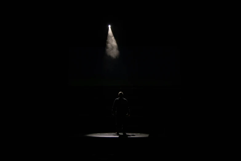 the spotlight is shining brightly on a dark stage with a spotlight