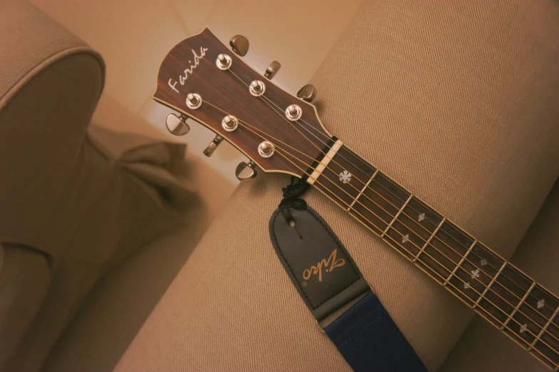 a wooden guitar is sitting on a cushion