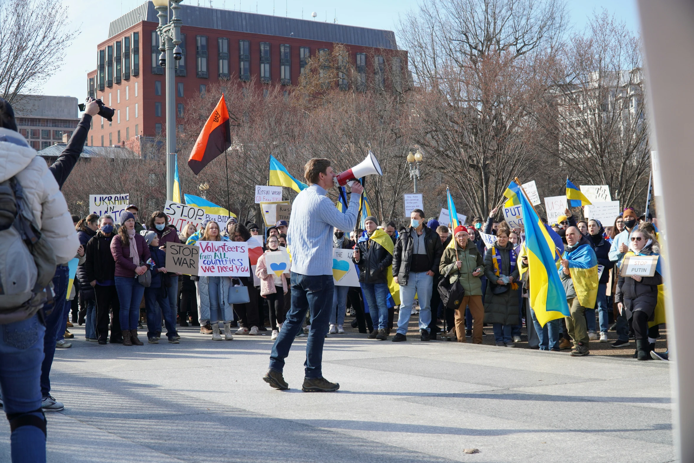 a crowd of people that are holding up signs