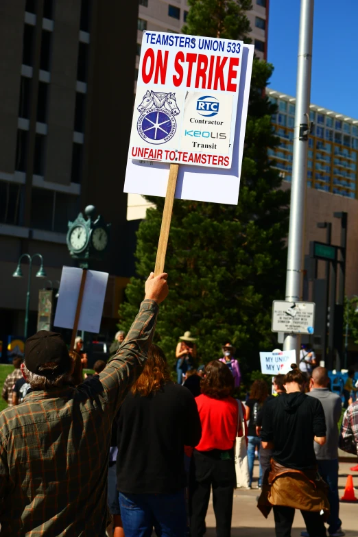 man holding up a sign during a protest