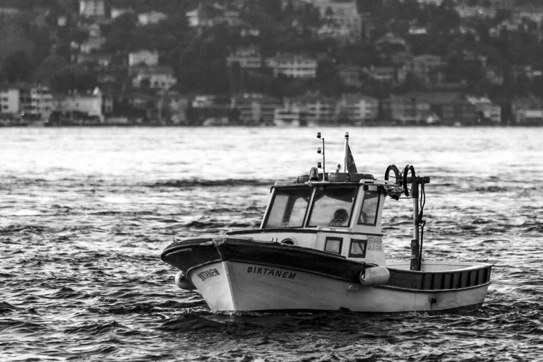 black and white po of a small boat in water