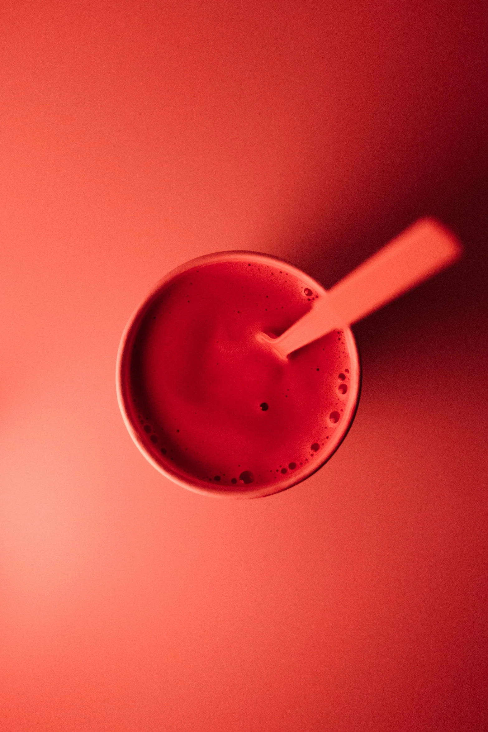 a red liquid inside of a small glass