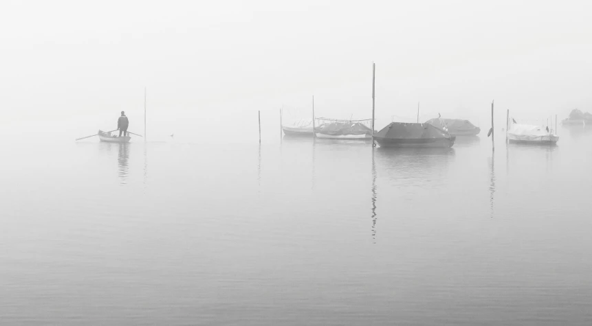 a row boat floating on top of a body of water