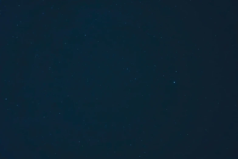 a person on top of a snowboard with night sky