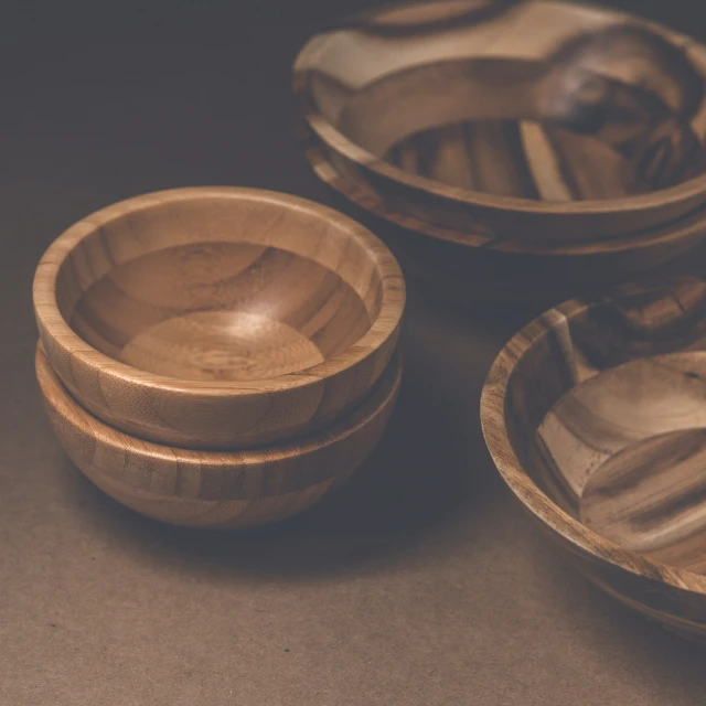 bowls on the table with an unusual carving on them