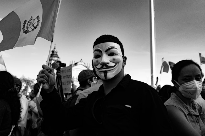 a person wearing a mask with faces painted