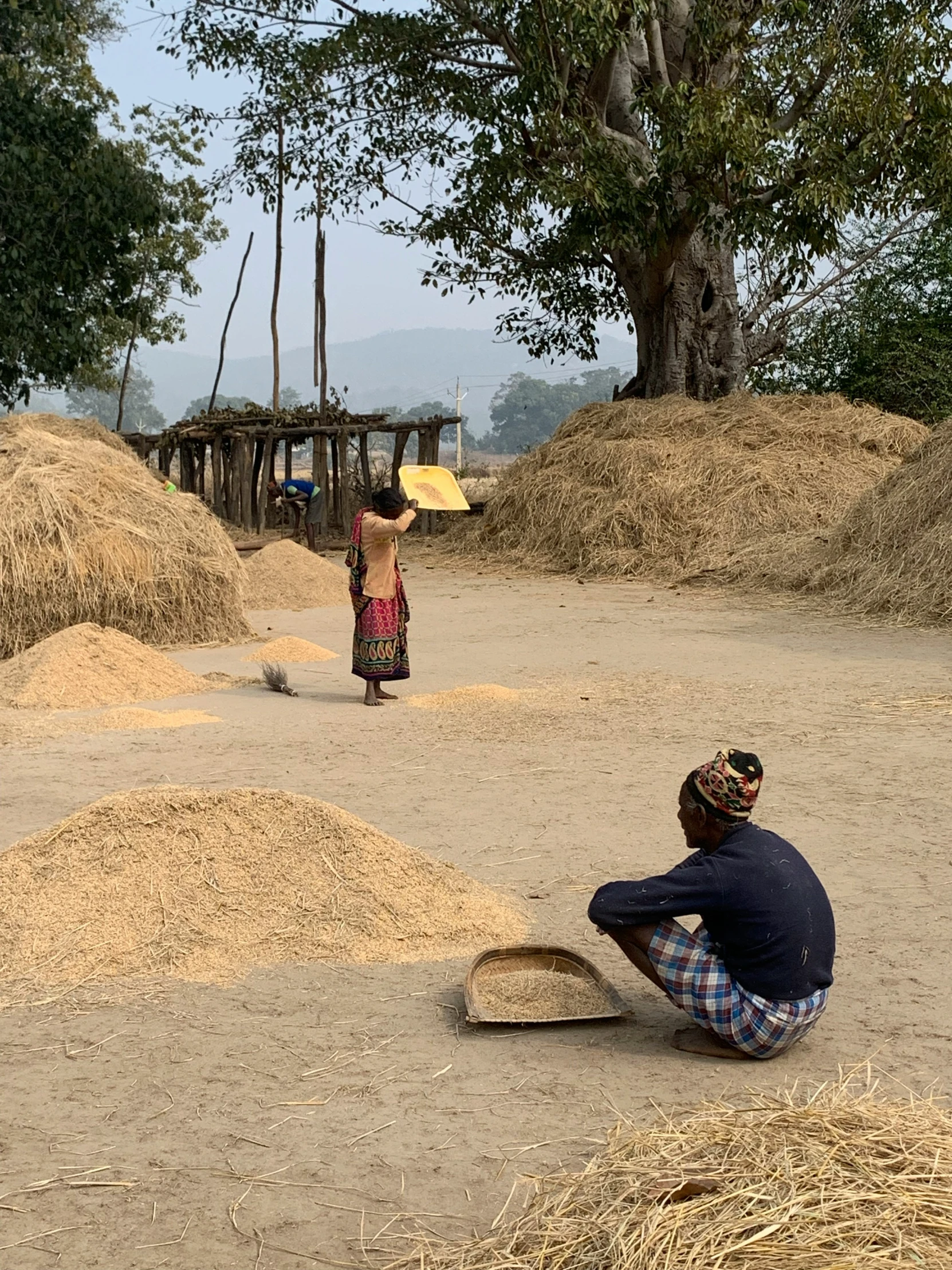 two people are working in an open - air setting