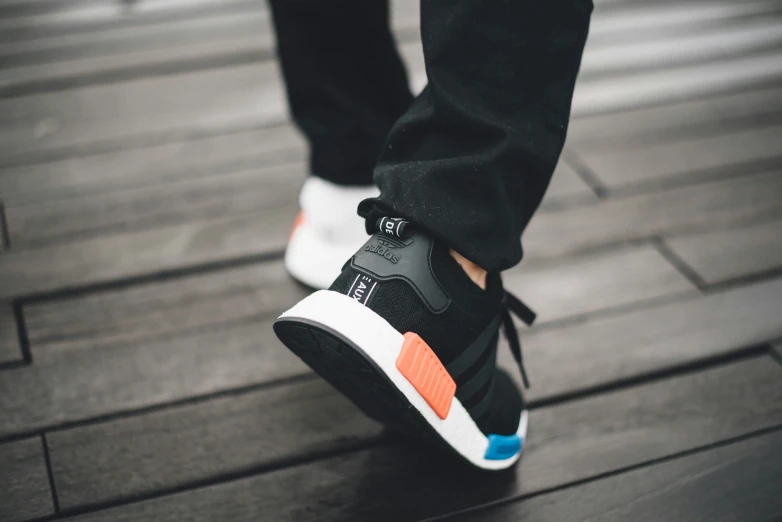 an overview of the adidas nm in black and orange