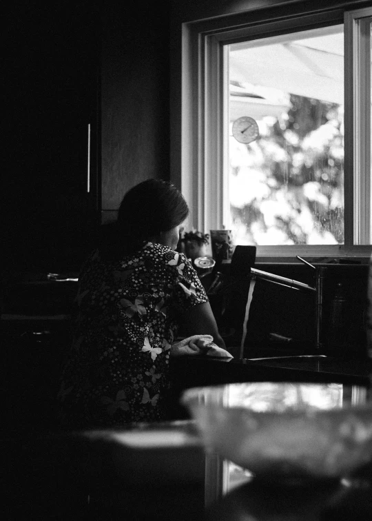 a woman in a chair is looking at a laptop