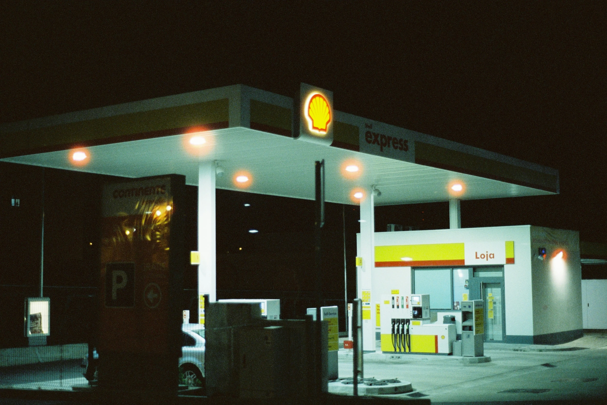 a gas station at night with its gas pump open