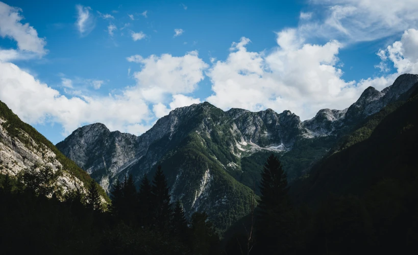 the top of the mountains is nearly covered in snow