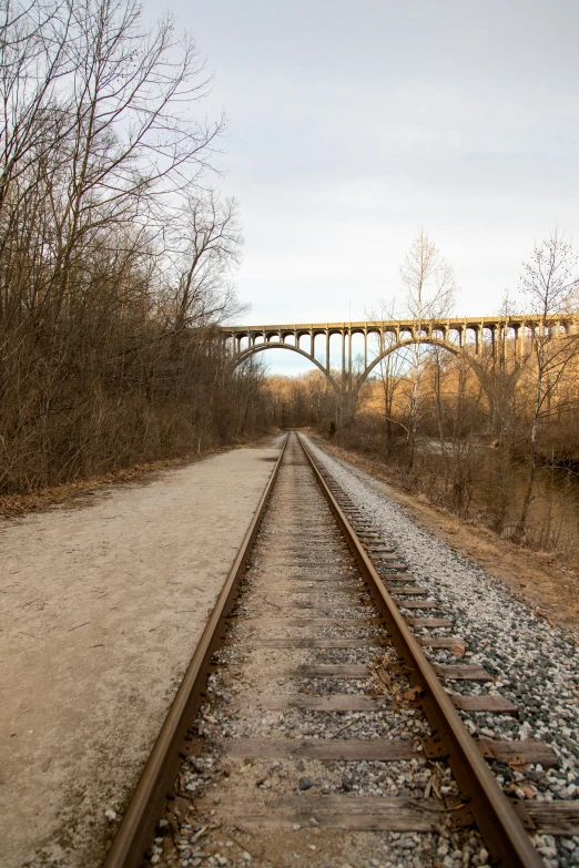 a train track near the river and a bridge