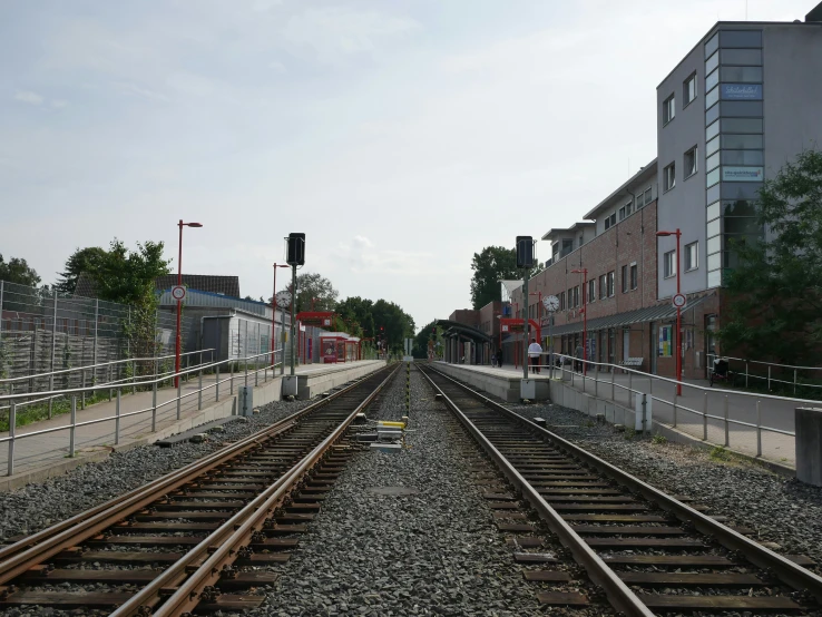 a train track with multiple tracks between buildings