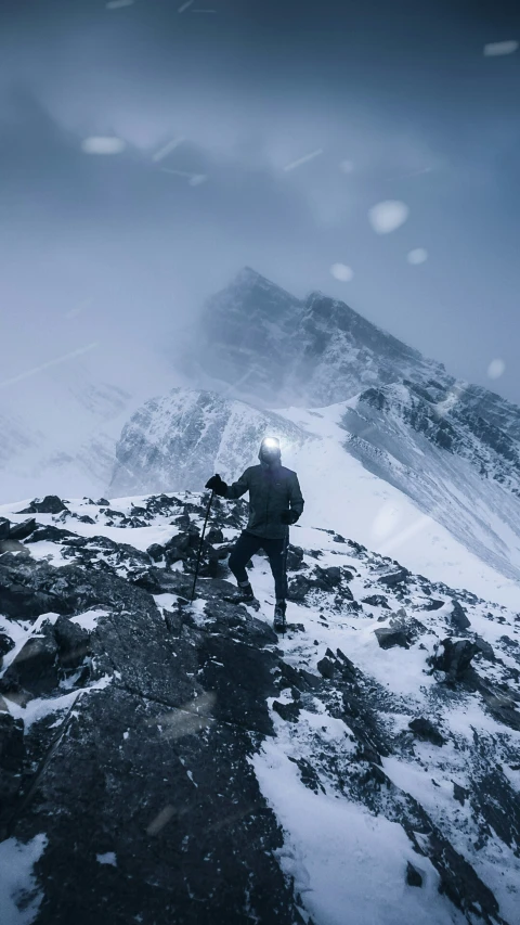 a mountain climber with their equipment on top of a hill