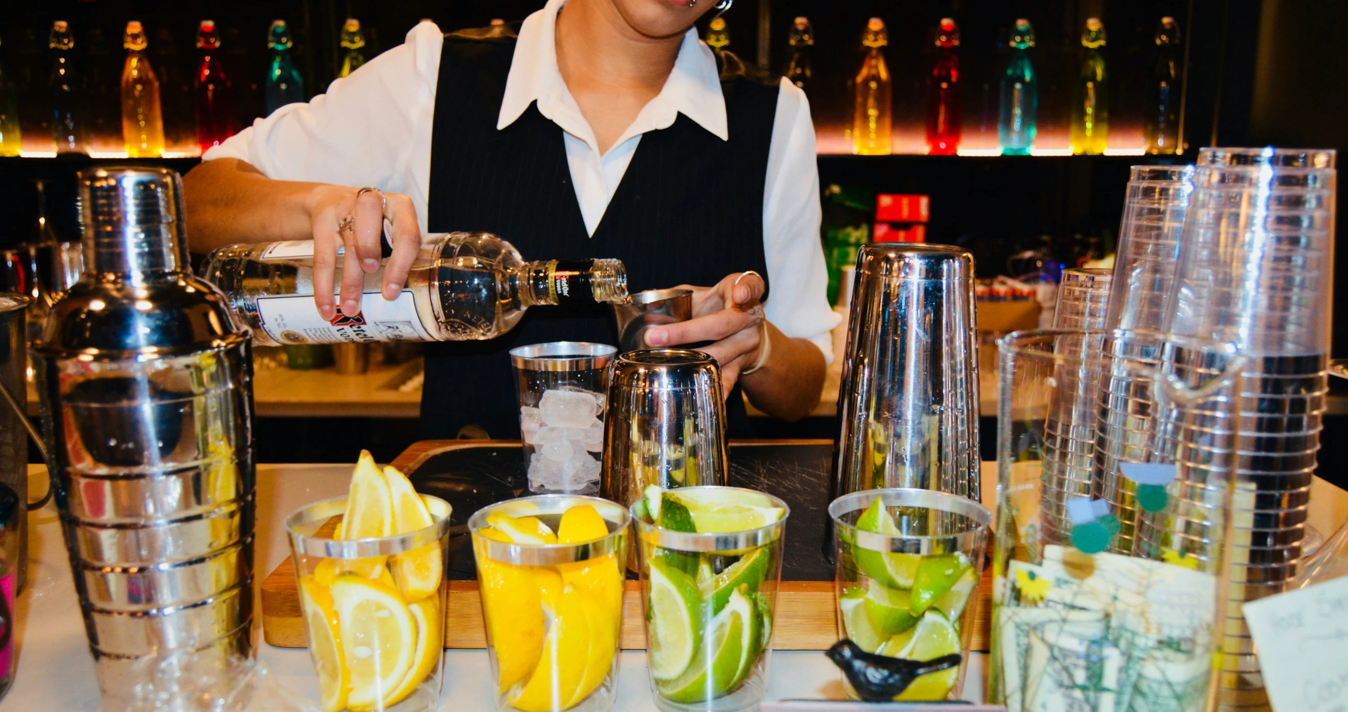 the bartender is mixing the drink at his bar