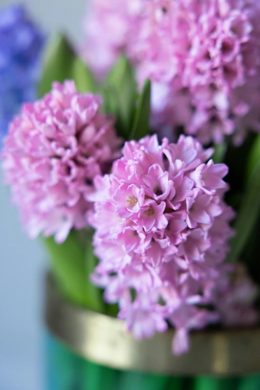 some pink and purple flowers in a green vase