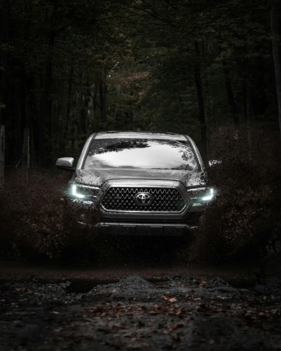 the front of a vehicle driving on a dirt road