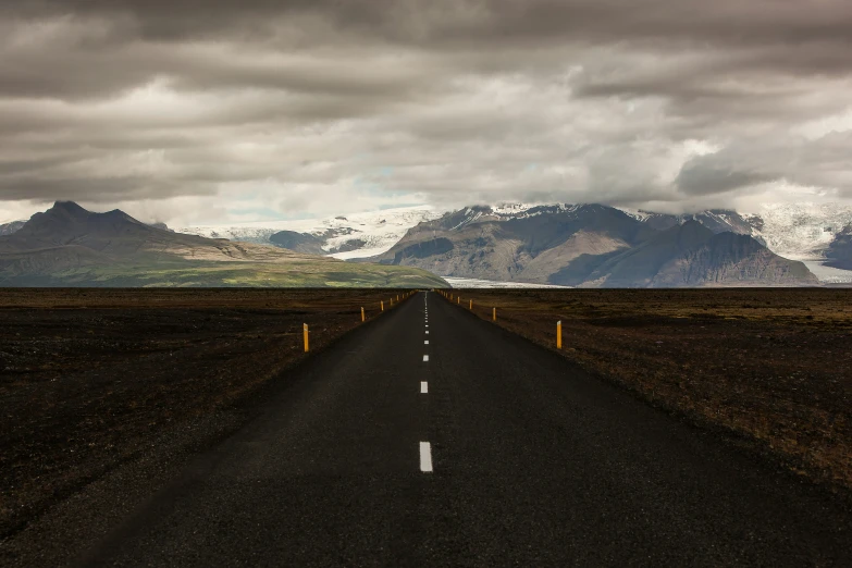 the long highway in the middle of a vast landscape