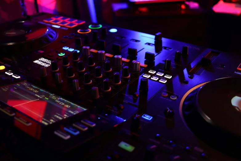 the music console and controller are illuminated by purple light