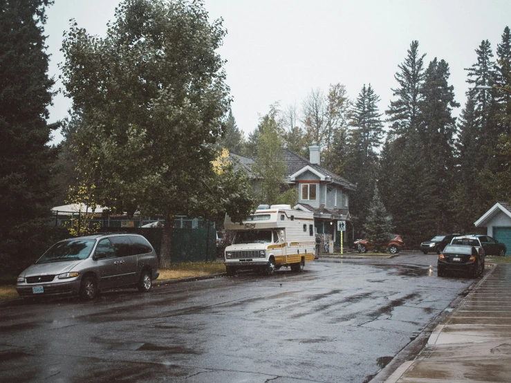 an rv is parked in a lot on a rainy day
