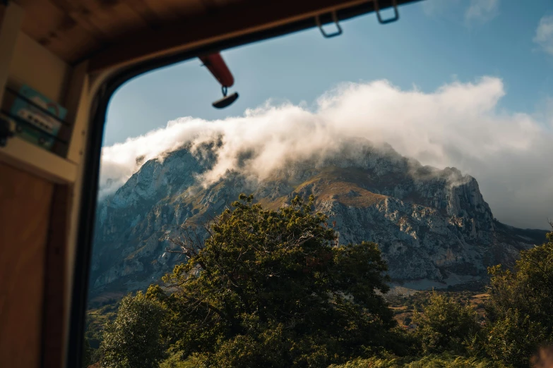 a view out of a window with trees below it