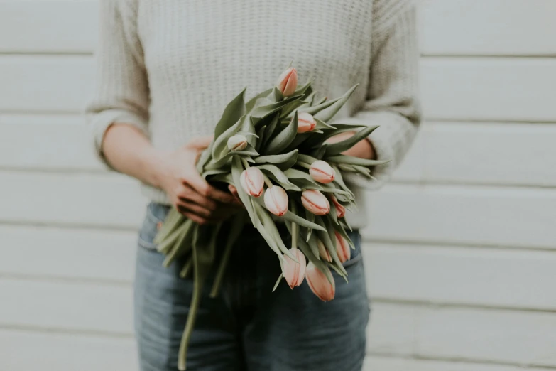 someone holding a bouquet of flowers on their hand