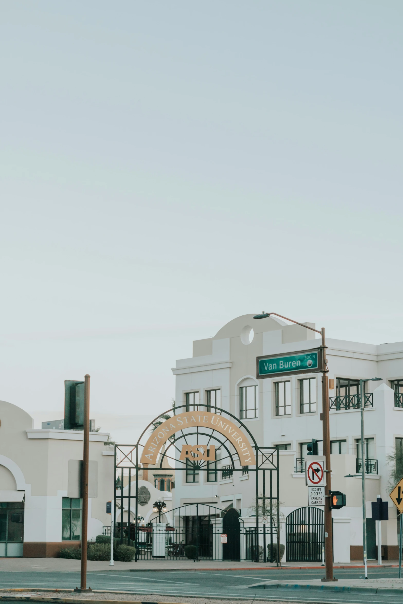 an empty street outside of a white building