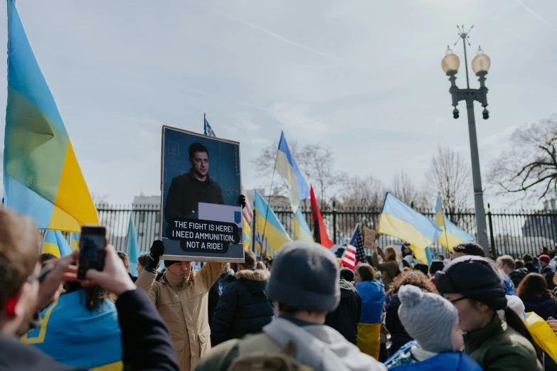 a man holding a sign that reads the people are not on this earth