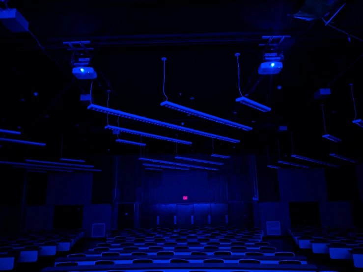 rows of chairs and stage lights in dark room
