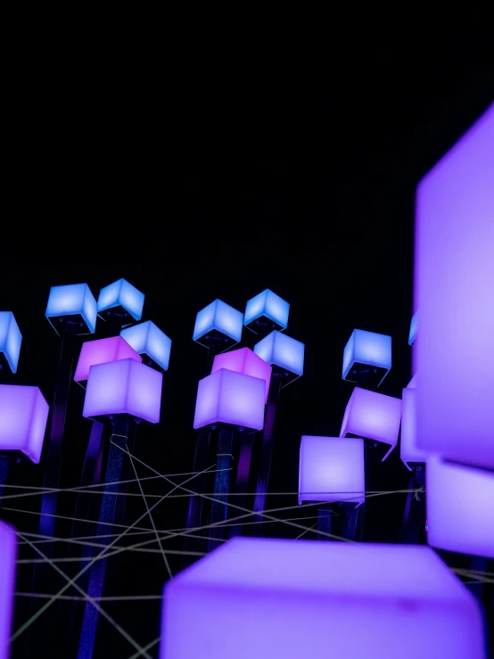 a row of purple and white lit up lamps