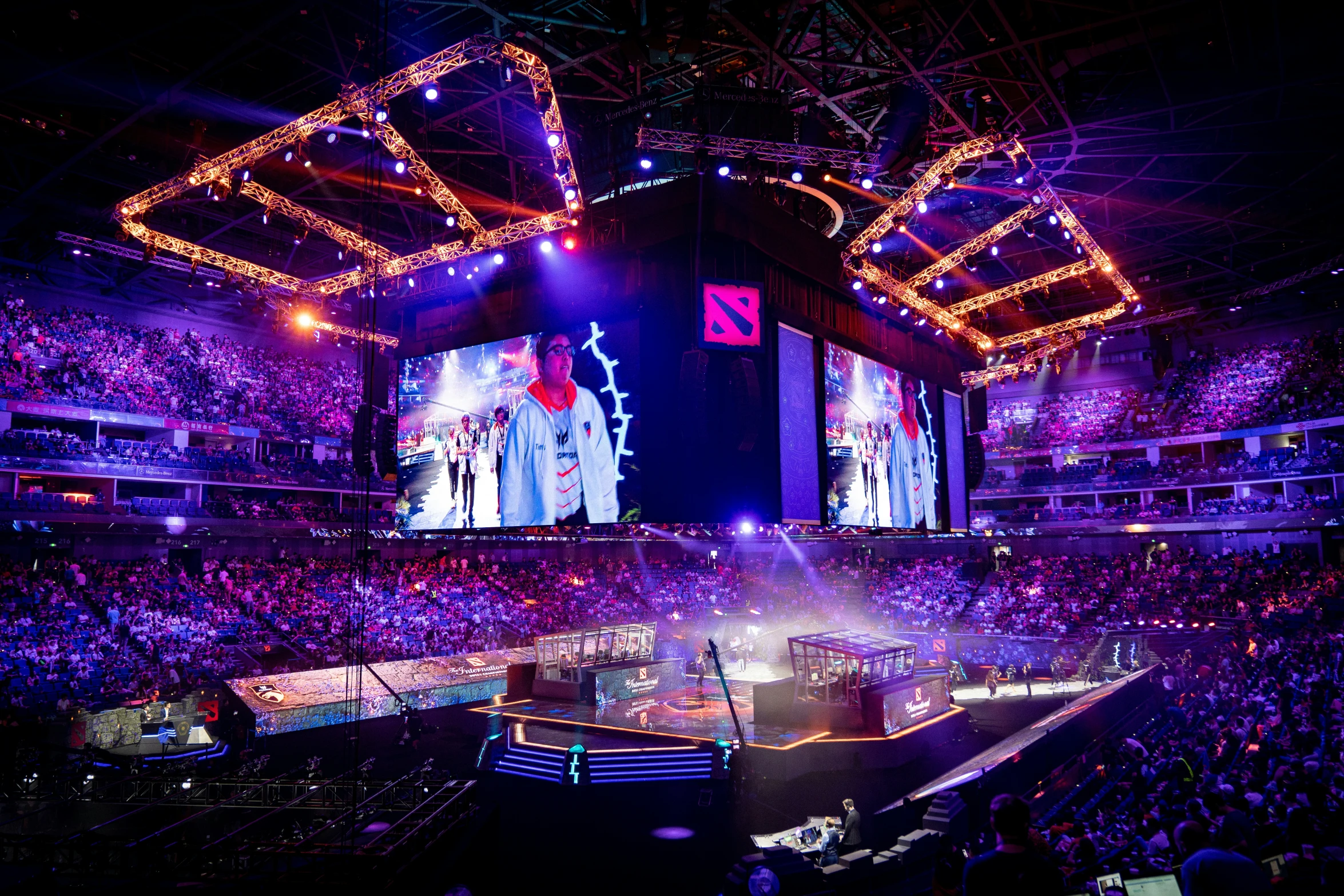 an arena full of people watching purple lites