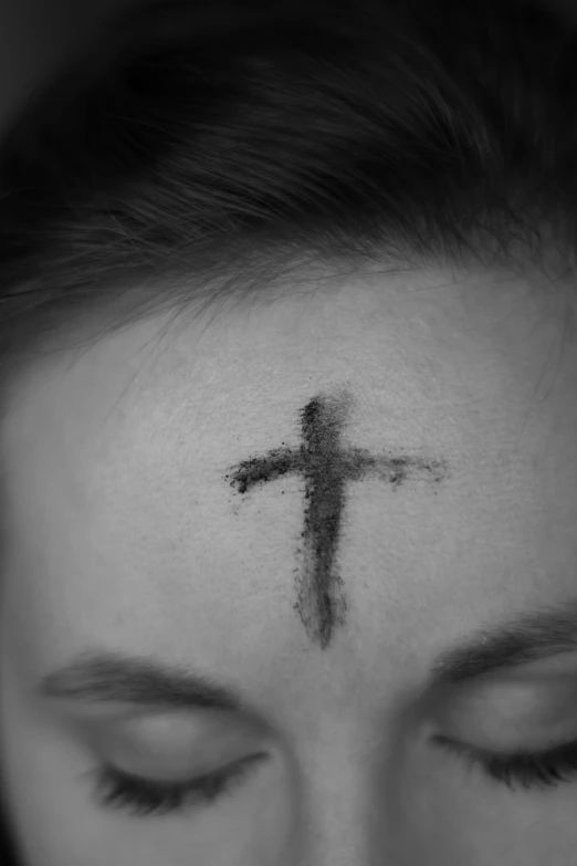 a woman with her face drawn like a cross