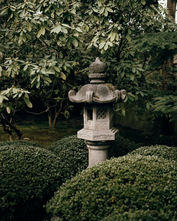 a stone lantern in the middle of a small garden