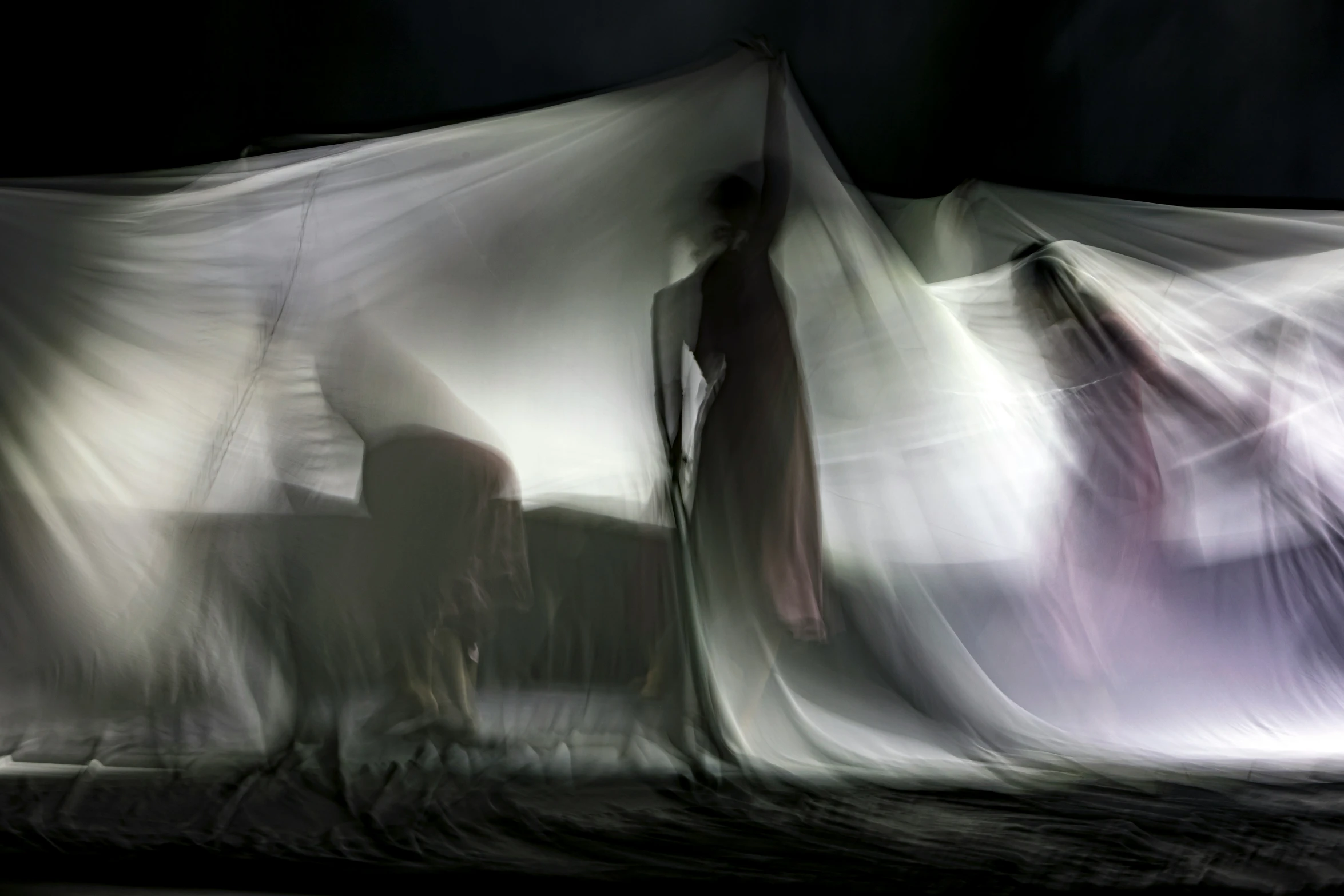 an image of a person and a chair under some sheets