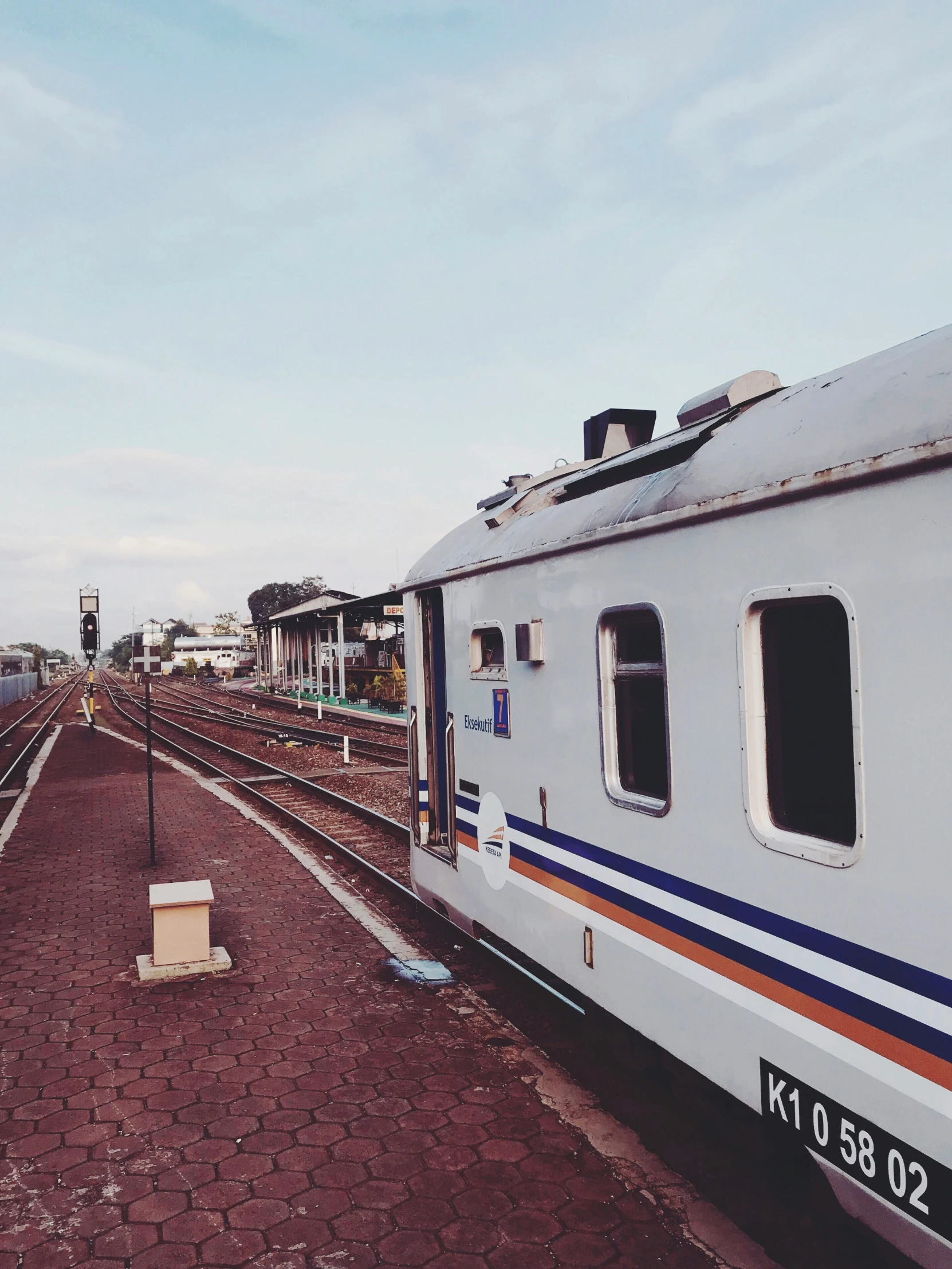 a train parked next to the shore in the distance