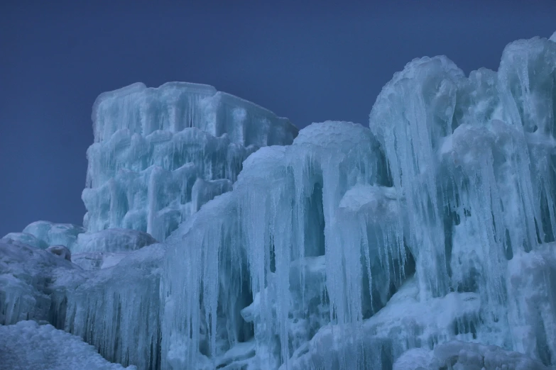 an ice covered mountain with frozen icicles