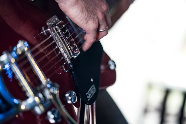 a close up s of a man playing a guitar