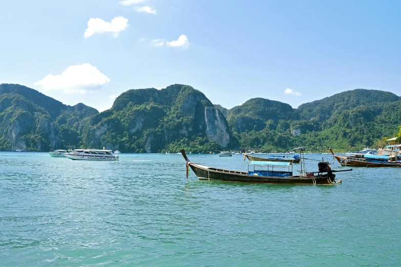 a boat floating on the water with some hills in the background