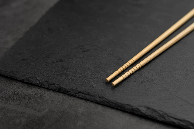 a close up of two chopsticks on a table